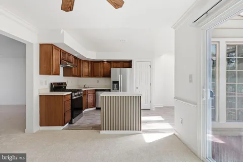a kitchen with stainless steel appliances granite countertop a refrigerator and a stove