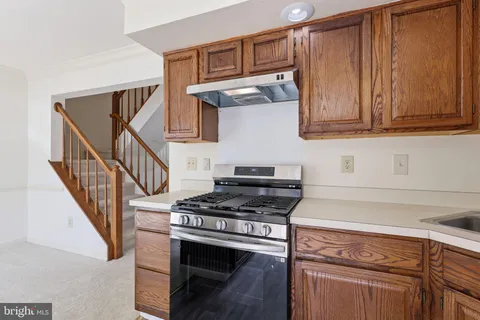 a kitchen with granite countertop a stove and a sink