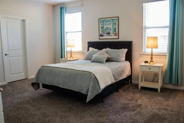 a bedroom with a bed a table and a window