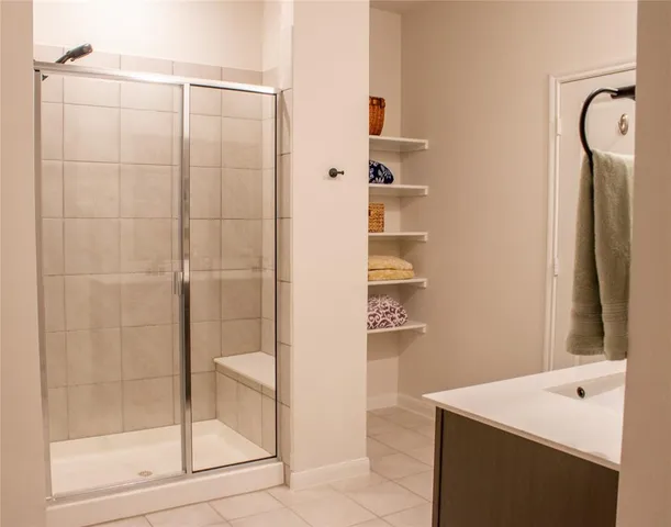 a bathroom with a shower and a sink