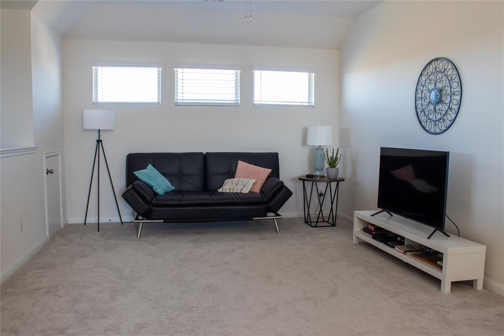 802 Range Drive Princeton, TX 75407 - Photo 15 of 20 a living room with furniture a flat screen tv and a fireplace