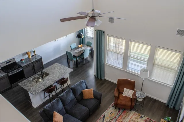 a living room with furniture and wooden floor