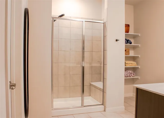 a bathroom with a shower and a glass door
