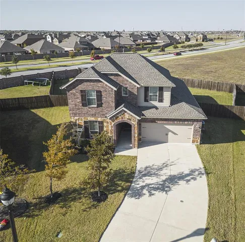 an aerial view of a house with a yard