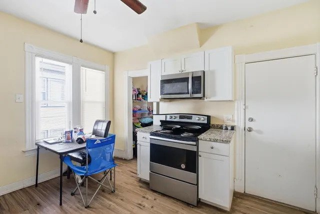 a kitchen with a stove a sink and a refrigerator