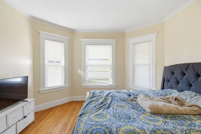 a bedroom with a bed and flat screen tv