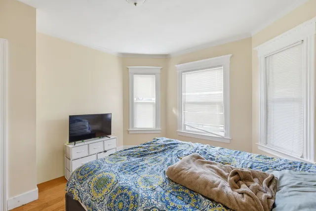 a bedroom with a bed and a television