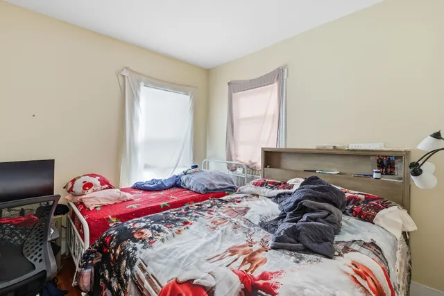 a bedroom with a bed and a tv