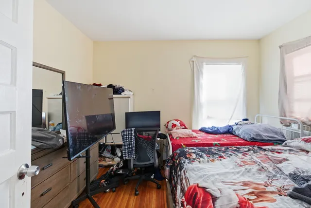 a bedroom with a bed and a fireplace