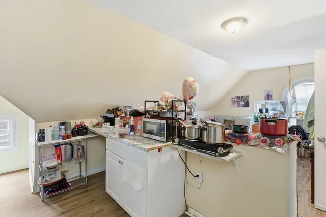 a bedroom with furniture and a wooden floor