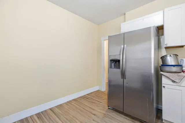 a view of a refrigerator in kitchen and wooden floor