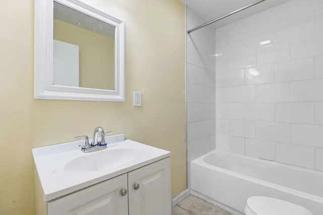 a bathroom with a sink toilet and bathtub