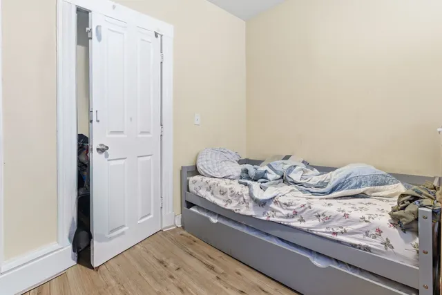 a bed sitting in a bedroom next to a window