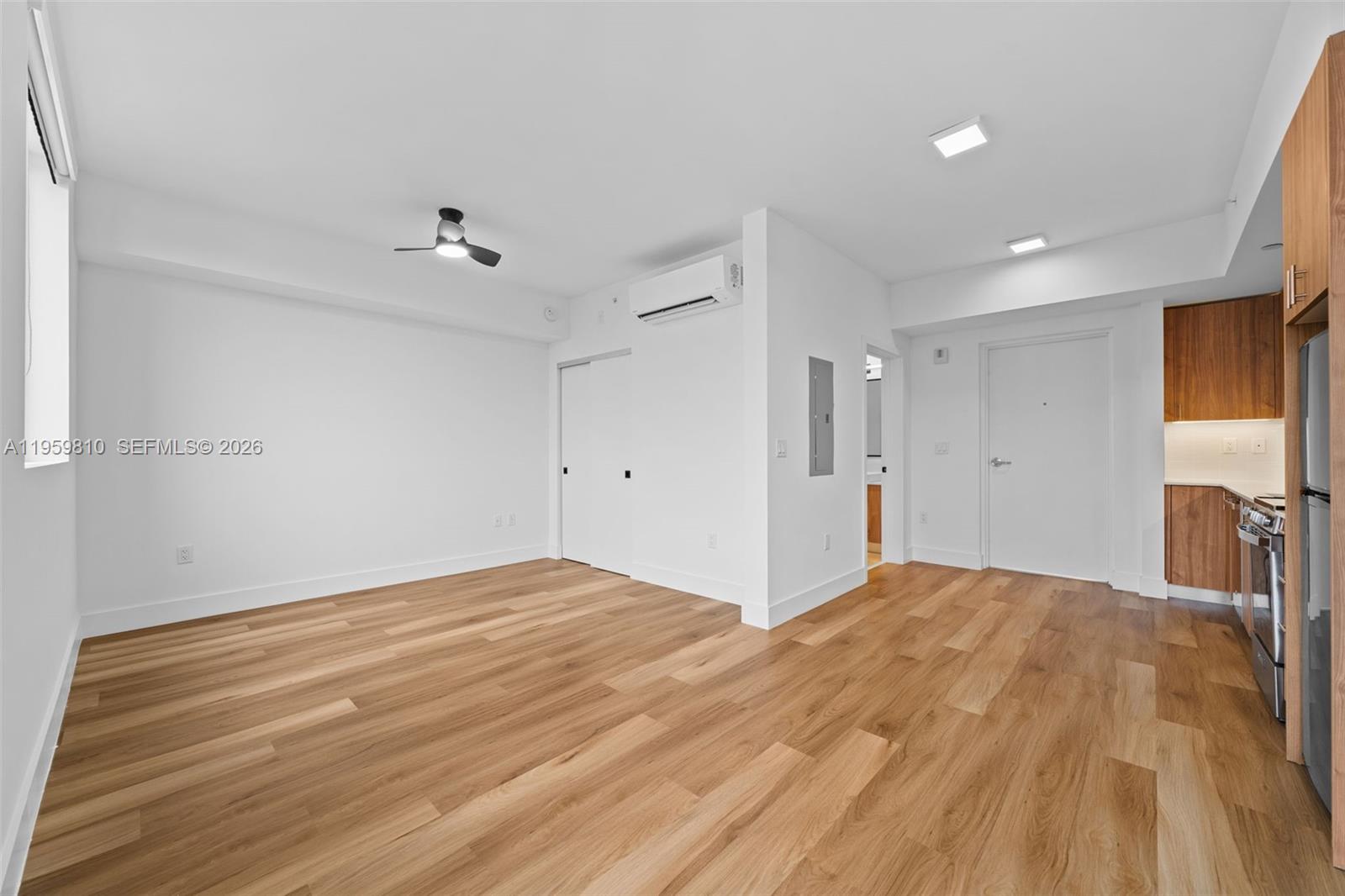 650 Southwest 1st Street, Unit 202 Miami, FL 33130 - Photo 4 of 15 a view of empty room with wooden floor and fan