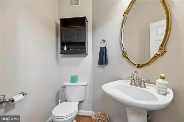 a bathroom with a sink a mirror and a toilet