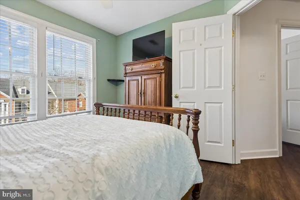 a bedroom with a bed and flat screen tv