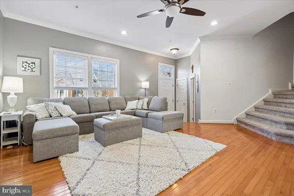 a living room with furniture and a wooden floor
