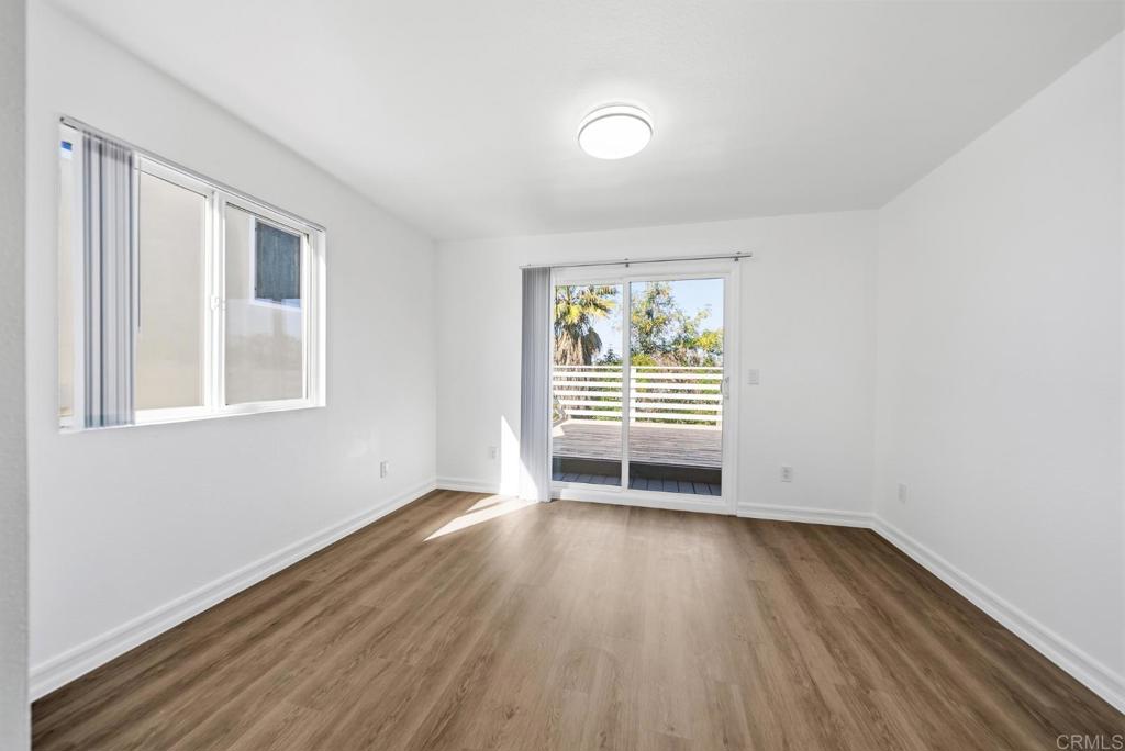 724 Felicita Avenue Spring Valley, CA 91977 - Photo 11 of 37 an empty room with wooden floor and windows