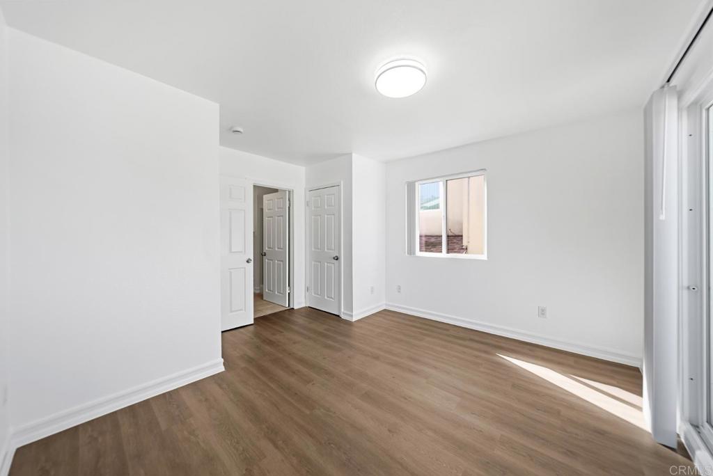 724 Felicita Avenue Spring Valley, CA 91977 - Photo 9 of 37 a view of an empty room with wooden floor and a window