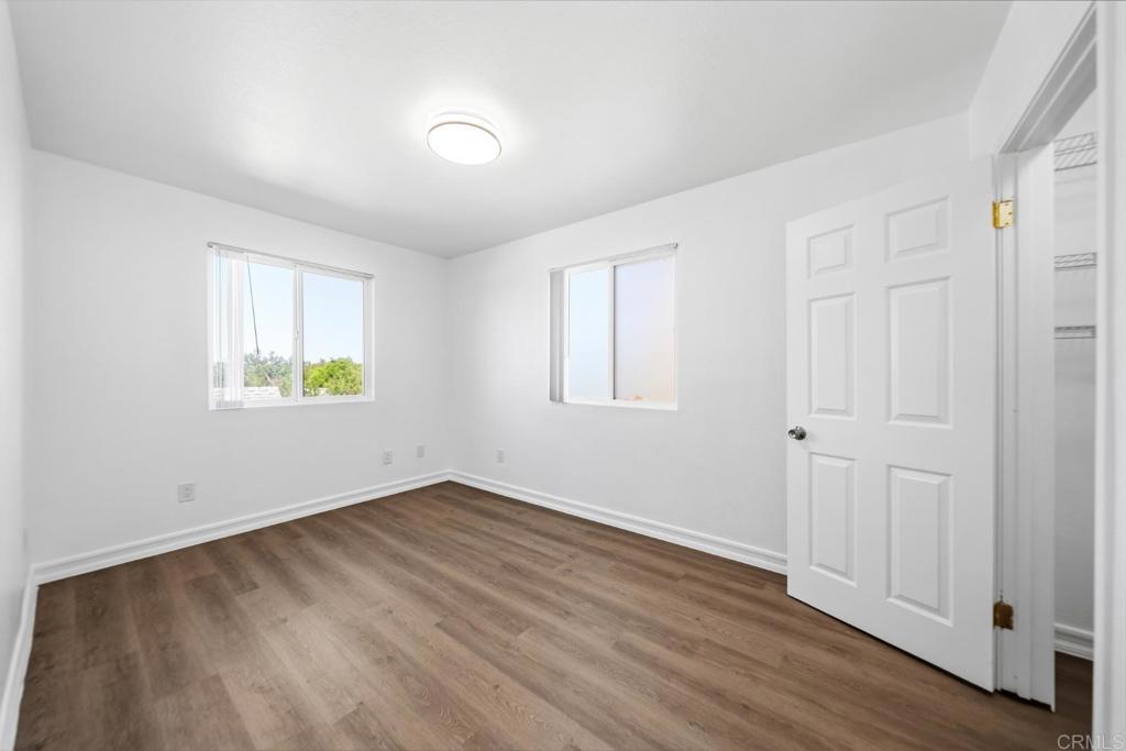 724 Felicita Avenue Spring Valley, CA 91977 - Photo 10 of 37 an empty room with wooden floor and windows