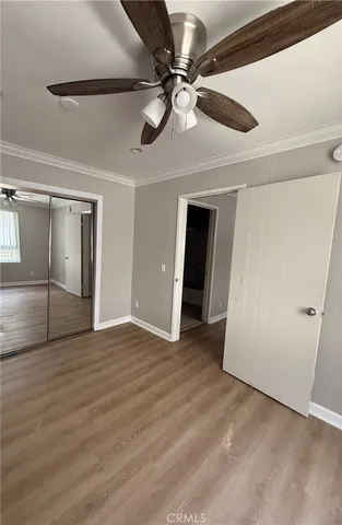 a view of an empty room with a ceiling fan