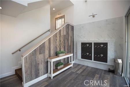 10900 Blix Street, Unit 4 North Hollywood, CA 91602 - Photo 7 of 10 a view of an entryway with wooden floor and stairs