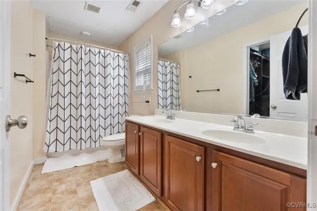 a view of swimming pool with a yard and a large tree in the background