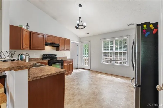 a kitchen with a sink stove and refrigerator