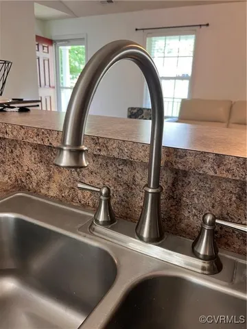 a view of kitchen with furniture and refrigerator