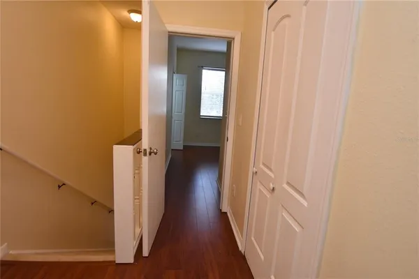 a view of a hallway with a wooden floor