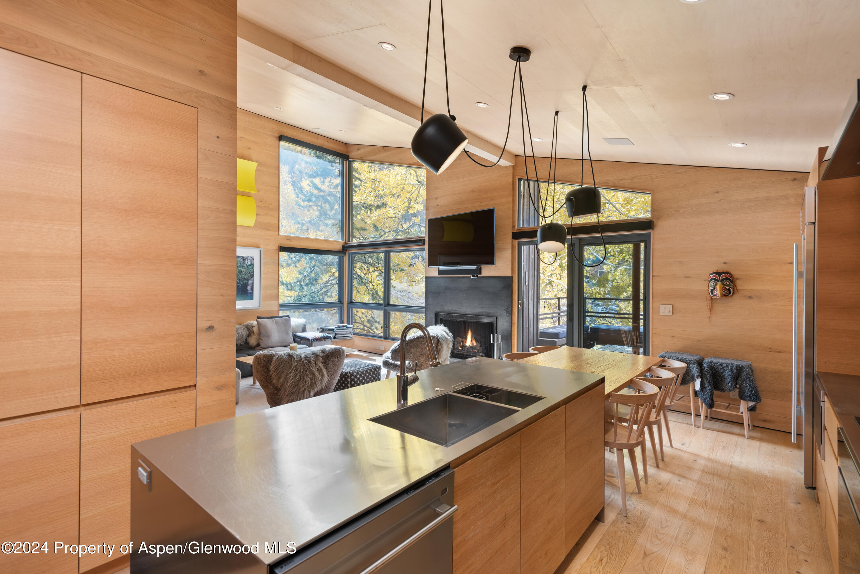 800 South Monarch Street, Unit 9 Aspen, CO 81611 - Photo 11 of 25 a kitchen with a table chairs and a window