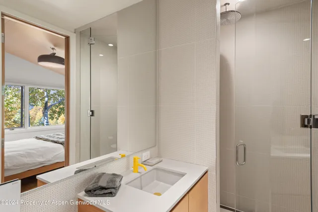 a bedroom with a bed and flat screen tv