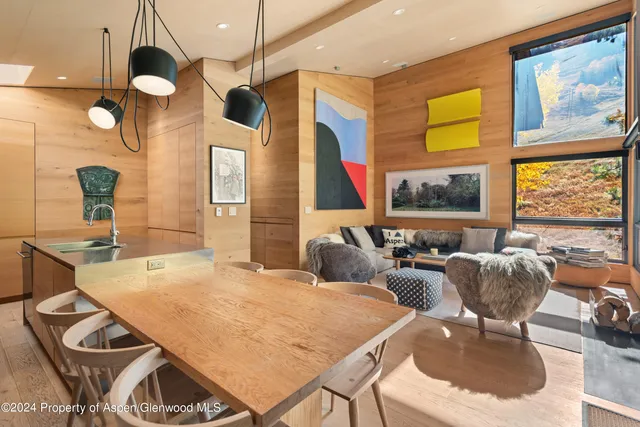 a living room with furniture a flat screen tv and a large window