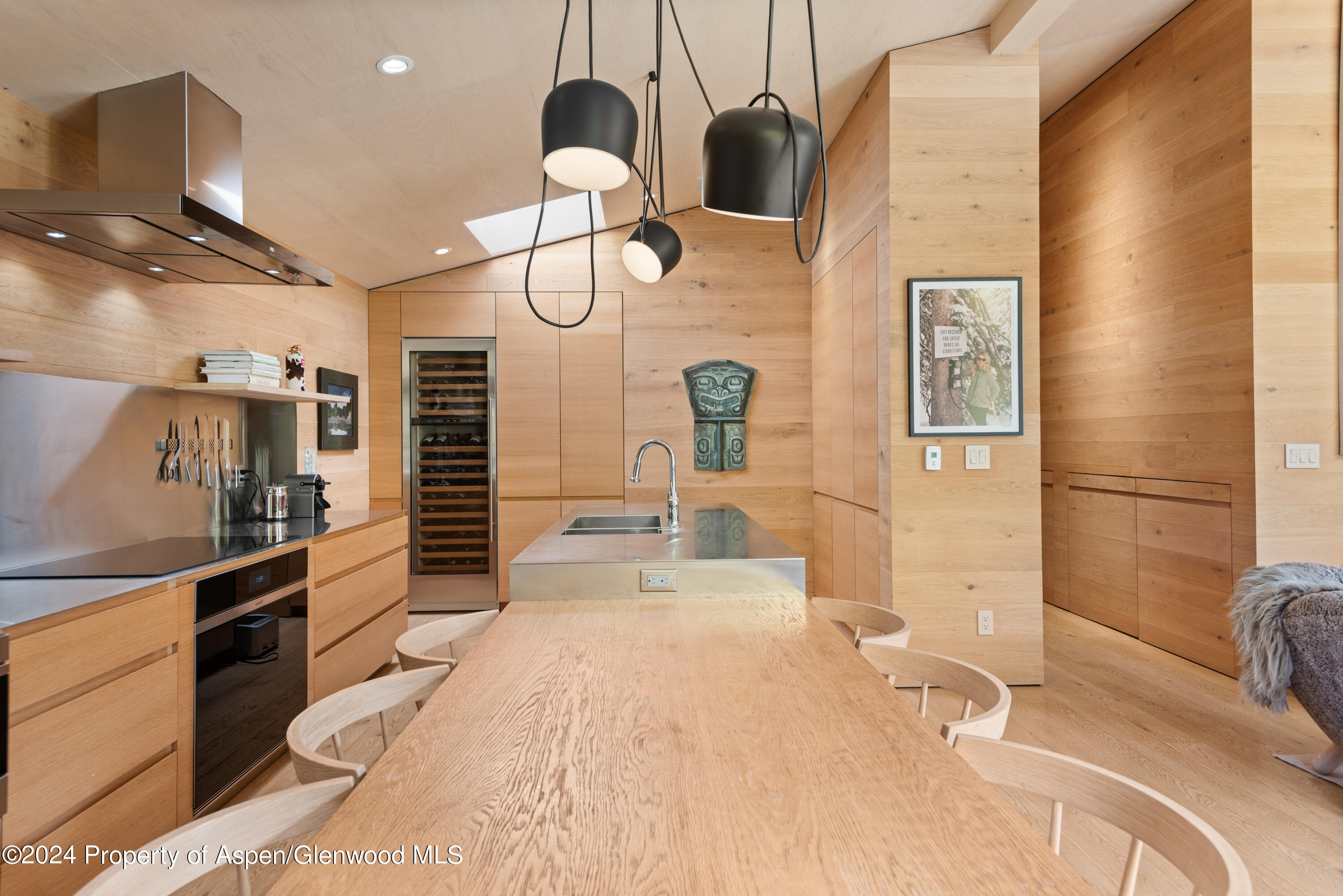 800 South Monarch Street, Unit 9 Aspen, CO 81611 - Photo 7 of 25 a large kitchen with kitchen island a large counter space a sink stainless steel appliances and cabinets