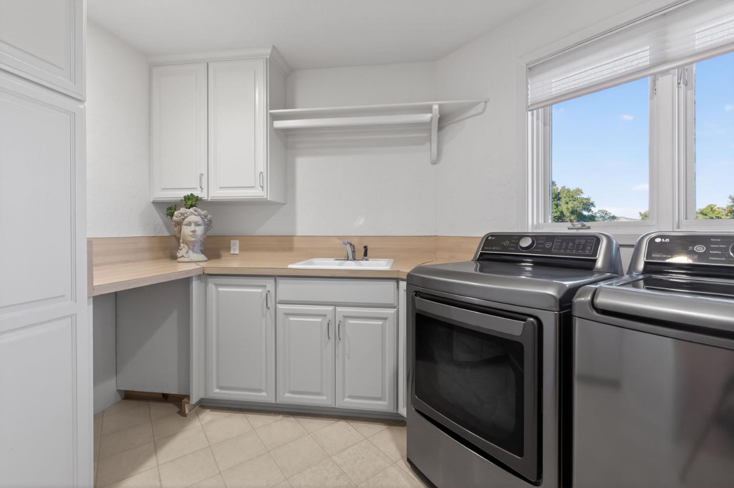 7570 Airola Road Vallecito, CA 95251 - Photo 78 of 90 a kitchen with granite countertop a sink stove and cabinets
