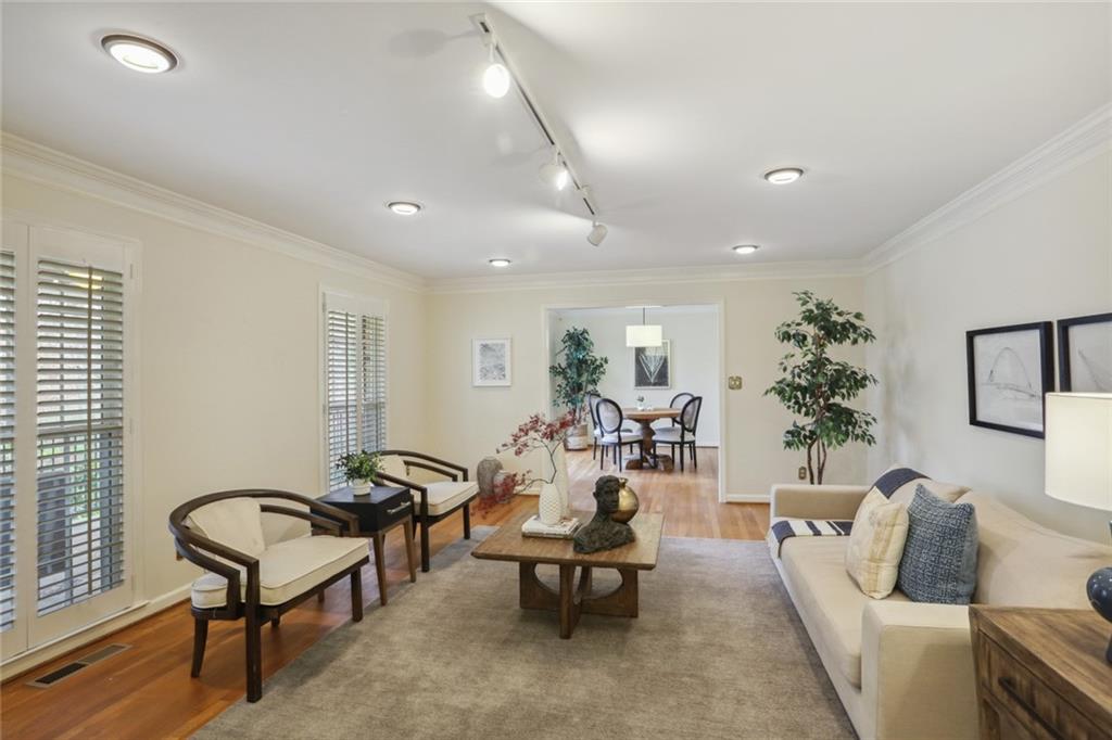 a living room with furniture and a potted plant