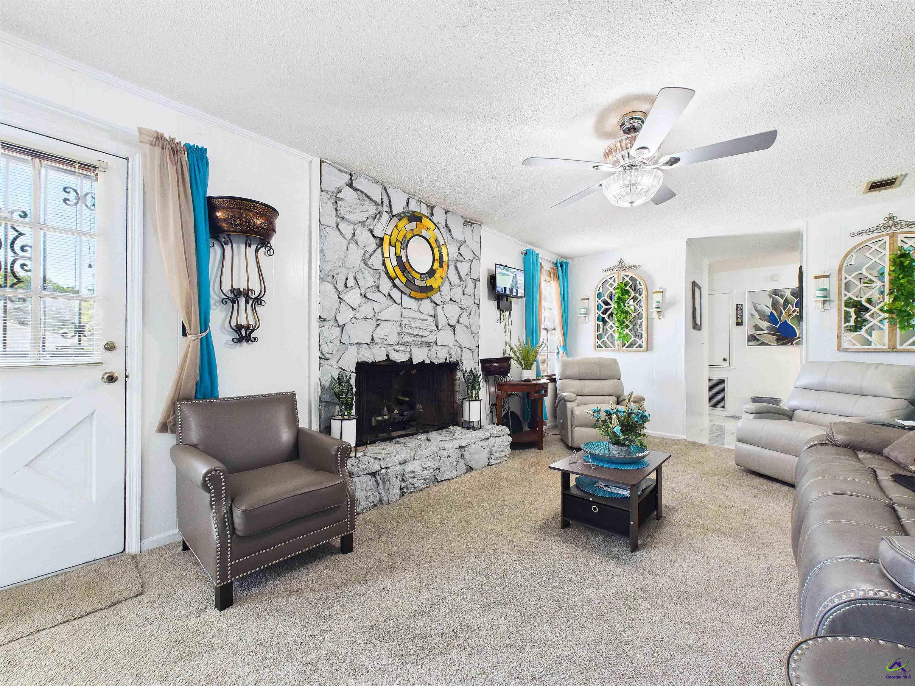 400 Feagin Mill Road Warner Robins, GA 31005 - Photo 21 of 53 a living room with furniture and a fireplace
