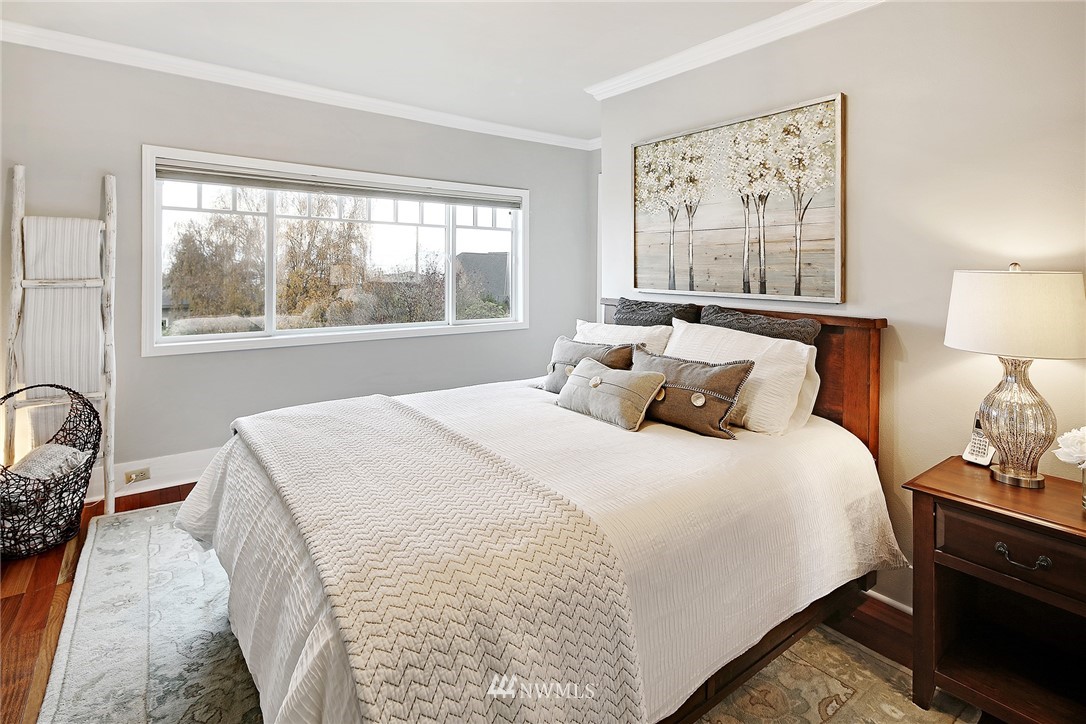 1936 47th Avenue Southwest Seattle, WA 98116 - Photo 12 of 25 a bedroom with a bed and a large window