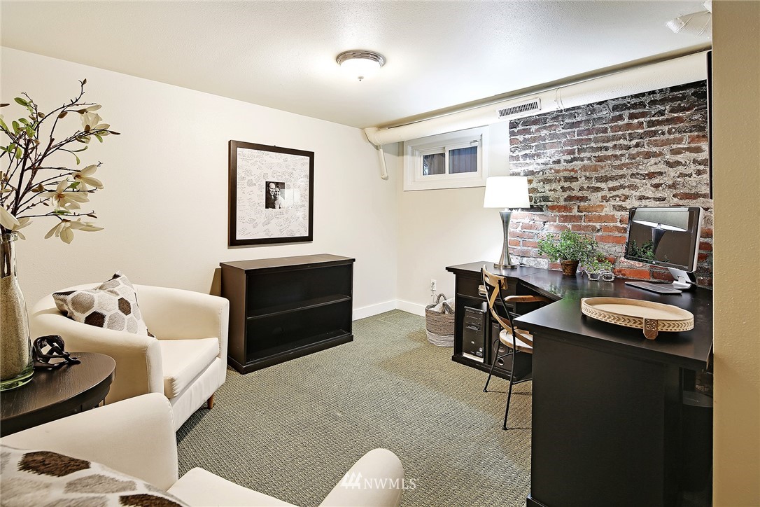 1936 47th Avenue Southwest Seattle, WA 98116 - Photo 16 of 25 a living room with furniture and a fireplace