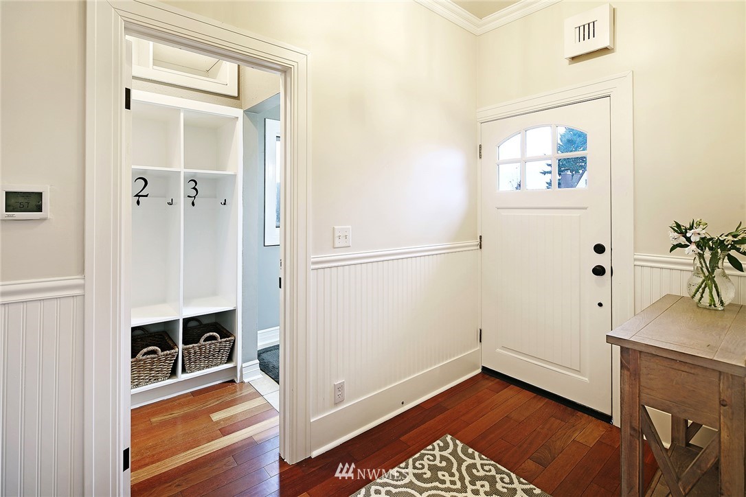 1936 47th Avenue Southwest Seattle, WA 98116 - Photo 3 of 25 a view of a hallway with wooden floor and a bathroom space