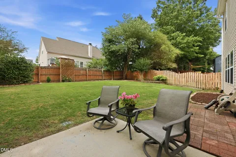 a view of backyard with seating area and green space