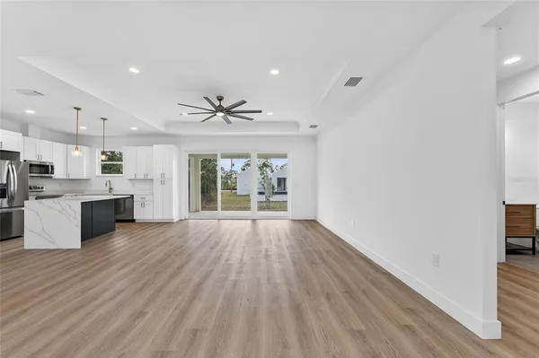 a view of a room with wooden floor and window