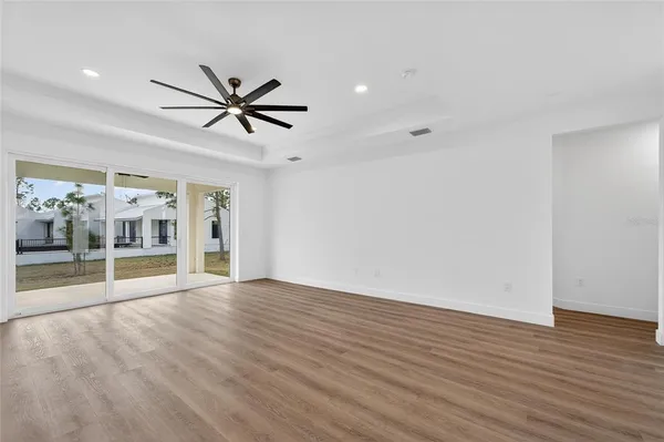 a kitchen with a refrigerator a sink and wooden floor
