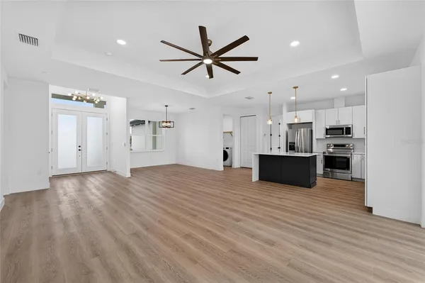 a kitchen with stainless steel appliances granite countertop a sink and a stove