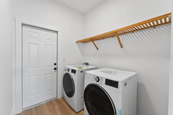 a white toilet sitting next to a white walls