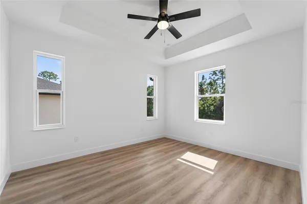 a view of a room with wooden floor and white walls
