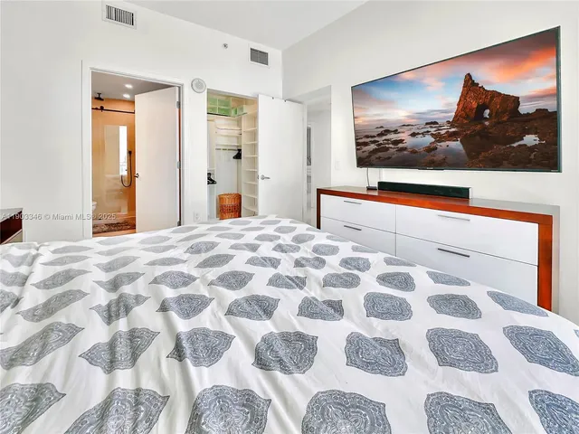 a bedroom with a bed and a view of bathroom