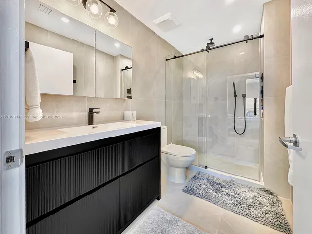 a bathroom with a sink toilet and shower