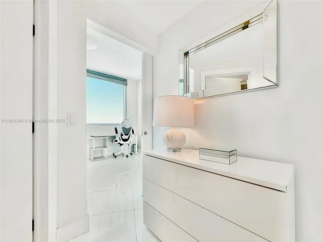 a bathroom with a bathtub sink and mirror