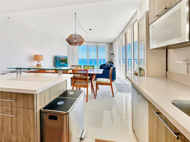 a kitchen with stainless steel appliances granite countertop a sink a stove and a wooden floors